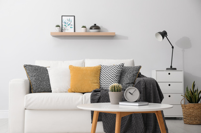 Photo of Elegant white sofa in modern living room interior