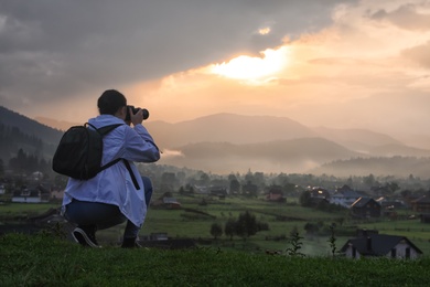 Professional nature photographer taking photos in mountains