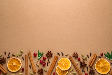 Photo of Different mulled wine ingredients on brown background, flat lay. Space for text