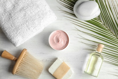 Flat lay composition with different body care products on white wooden background