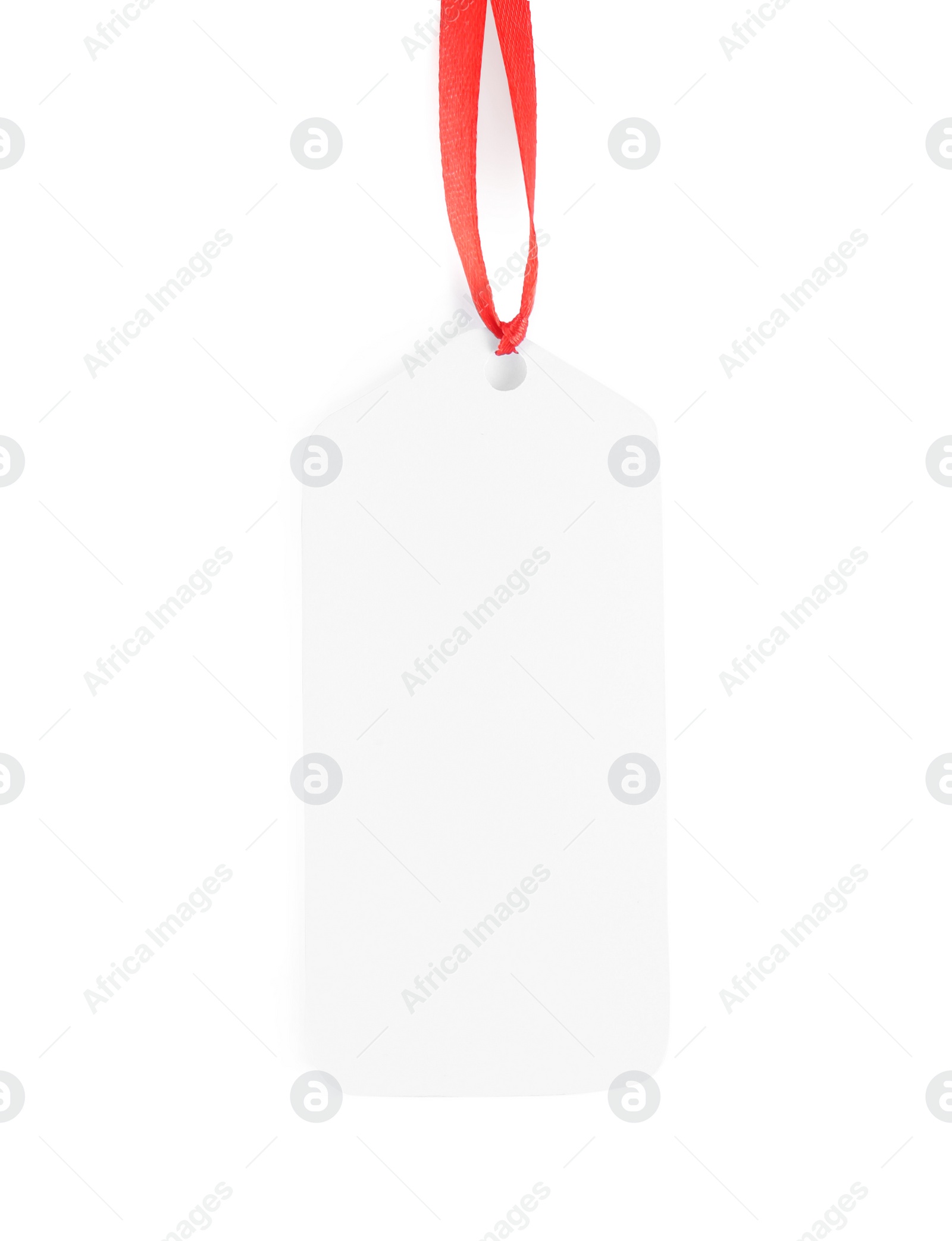 Photo of Blank gift tag with red satin ribbon on white background, top view