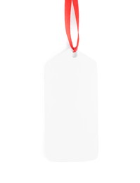 Blank gift tag with red satin ribbon on white background, top view