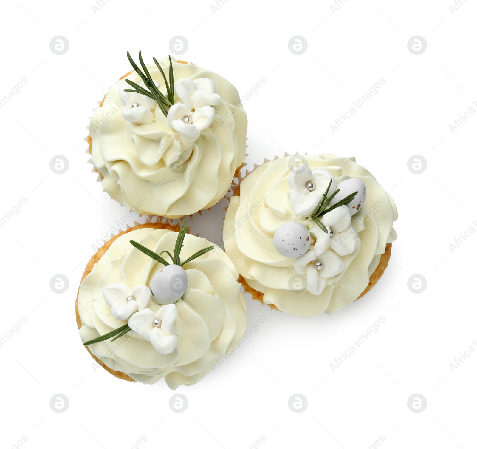 Photo of Tasty Easter cupcakes with vanilla cream isolated on white, top view