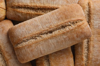 Photo of Crispy ciabattas as background, top view. Fresh bread