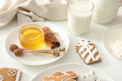 Delicious homemade Christmas cookies and ingredients on white table