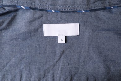 Photo of Clothing label on grey garment, top view