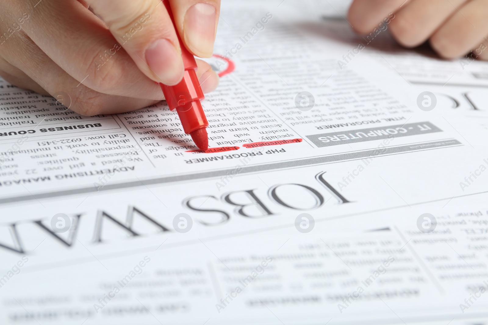 Photo of Woman marking advertisement in newspaper, closeup. Job search concept