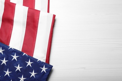 Photo of National flag of America and space for text on white wooden table, top view