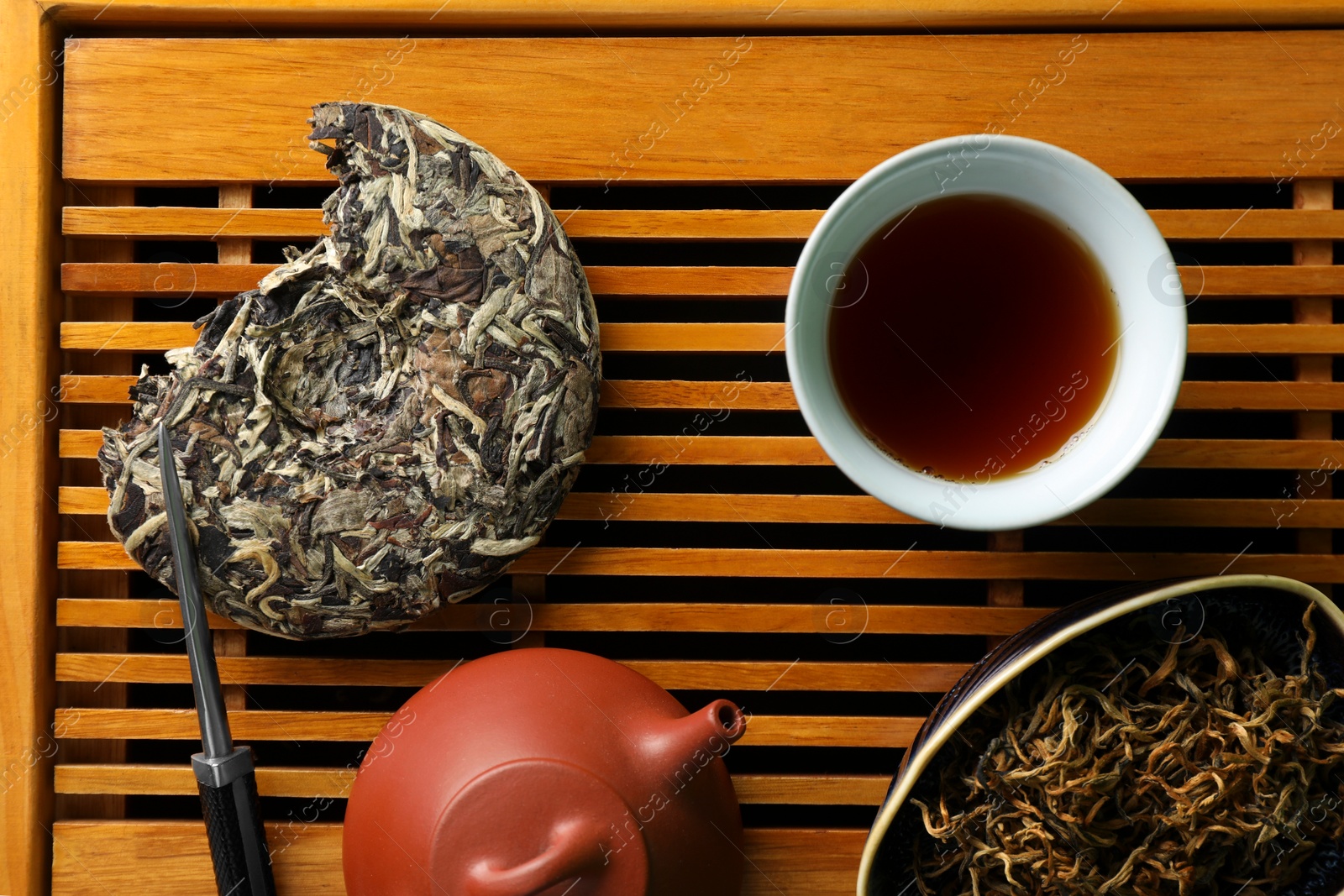 Photo of Traditional tea ceremony arrangement on wooden tray, flat lay