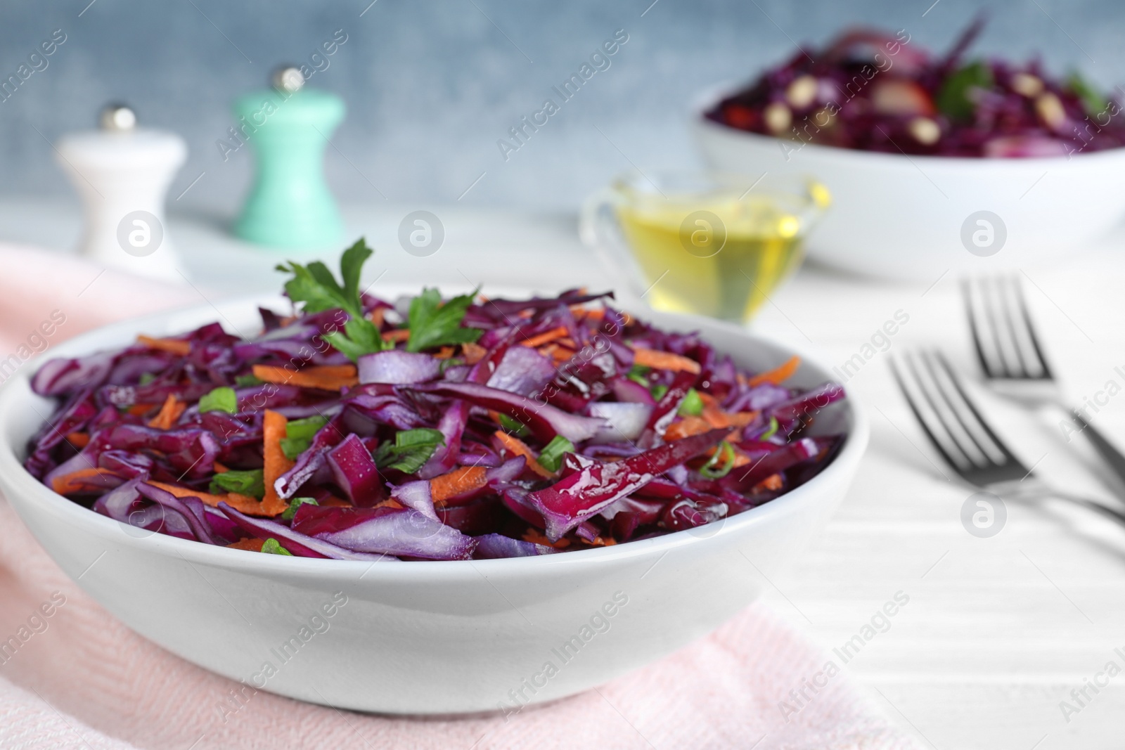 Photo of Fresh red cabbage salad served on white table, closeup