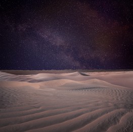 Image of Scenic view of sandy desert under starry sky in night 