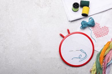 Photo of Flat lay composition with embroidery hoop on light grey background, top view. Space for text