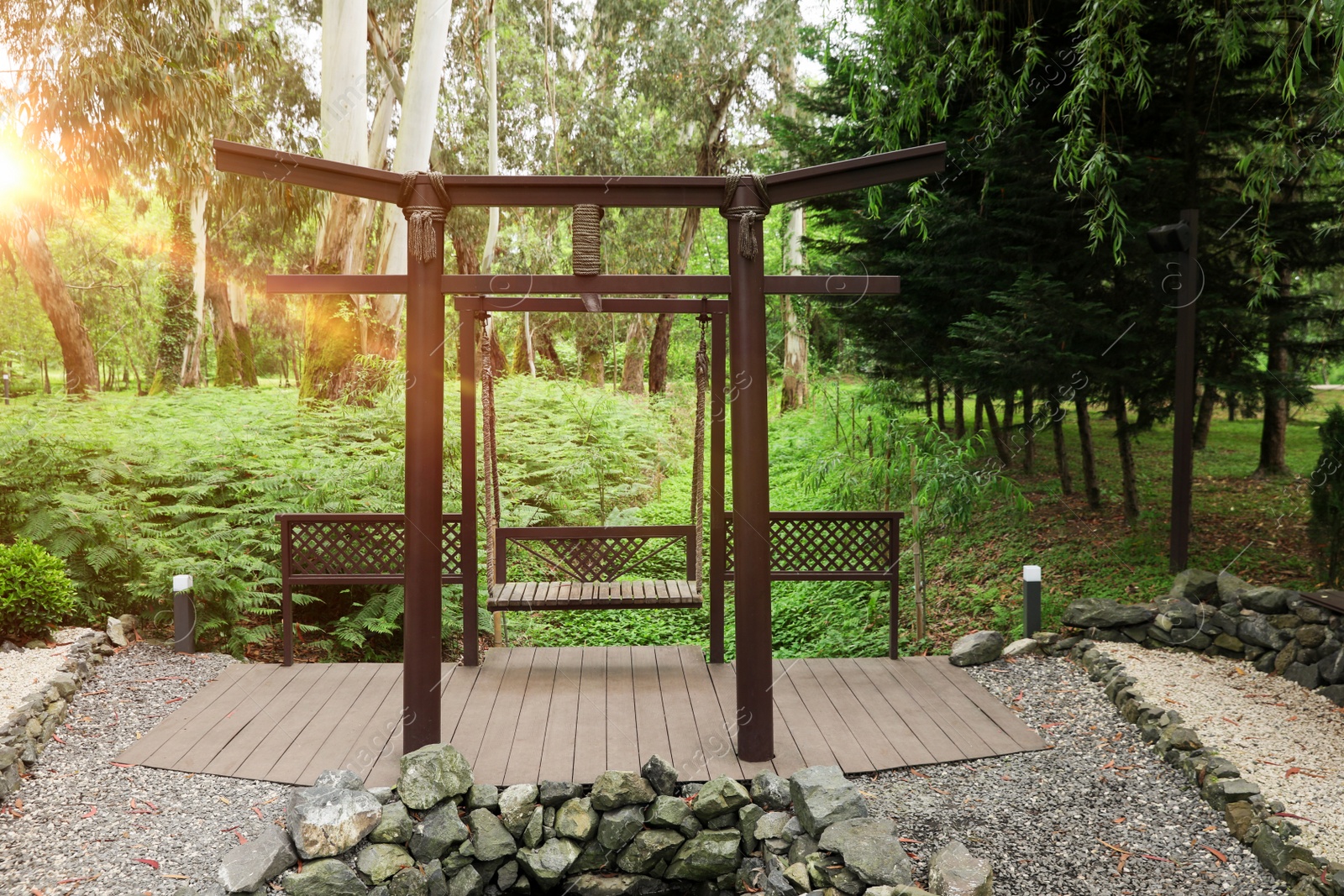 Photo of Beautiful brown metal swing in tranquil park