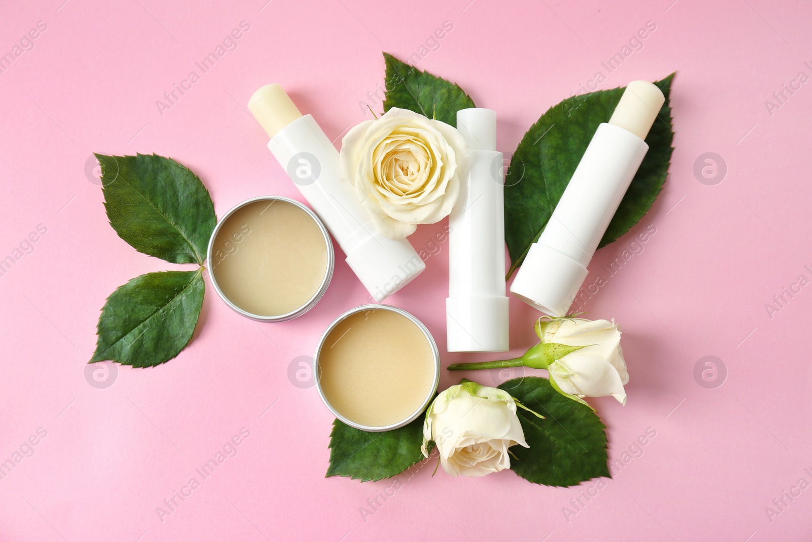 Photo of Flat lay composition with hygienic lipsticks and balms on color background