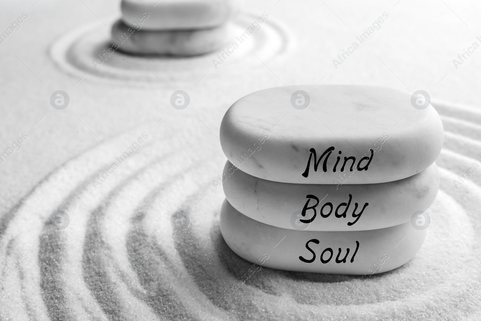 Image of Stones with words Mind, Body, Soul on sand, space for text. Zen and harmony 