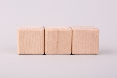 Photo of International Organization for Standardization. Cubes with abbreviation ISO on light grey background, closeup