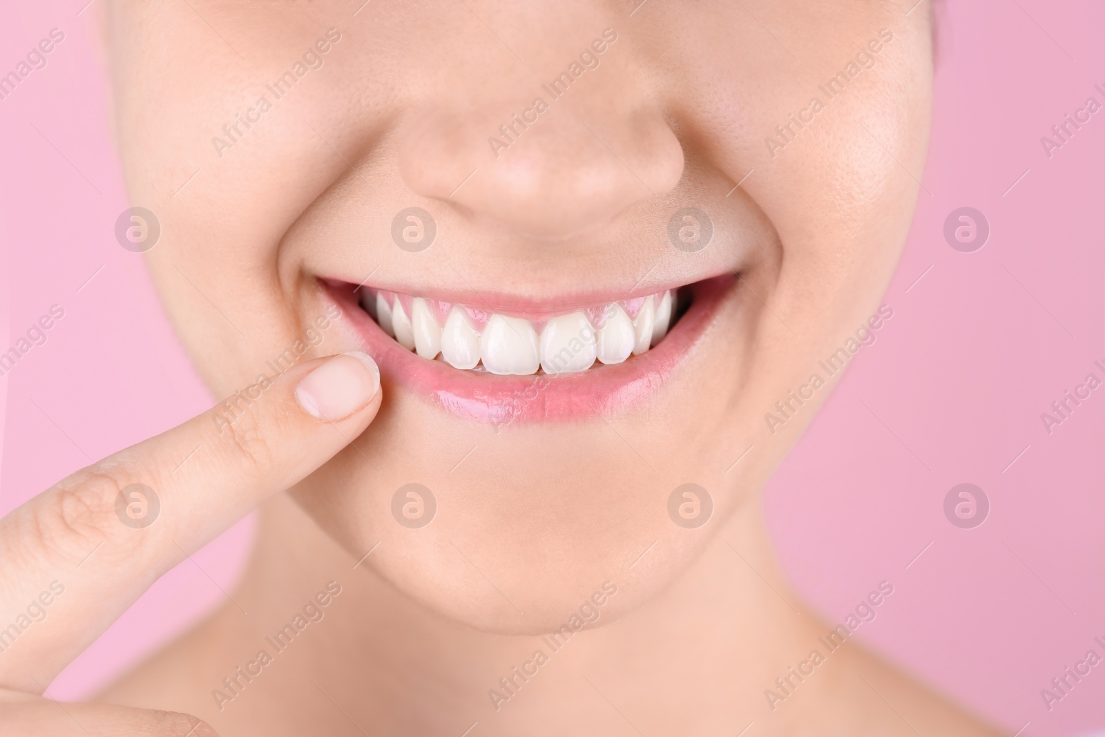 Photo of Young woman with beautiful smile on color background, closeup