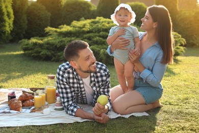 Photo of Happy family having picnic in garden on sunny day