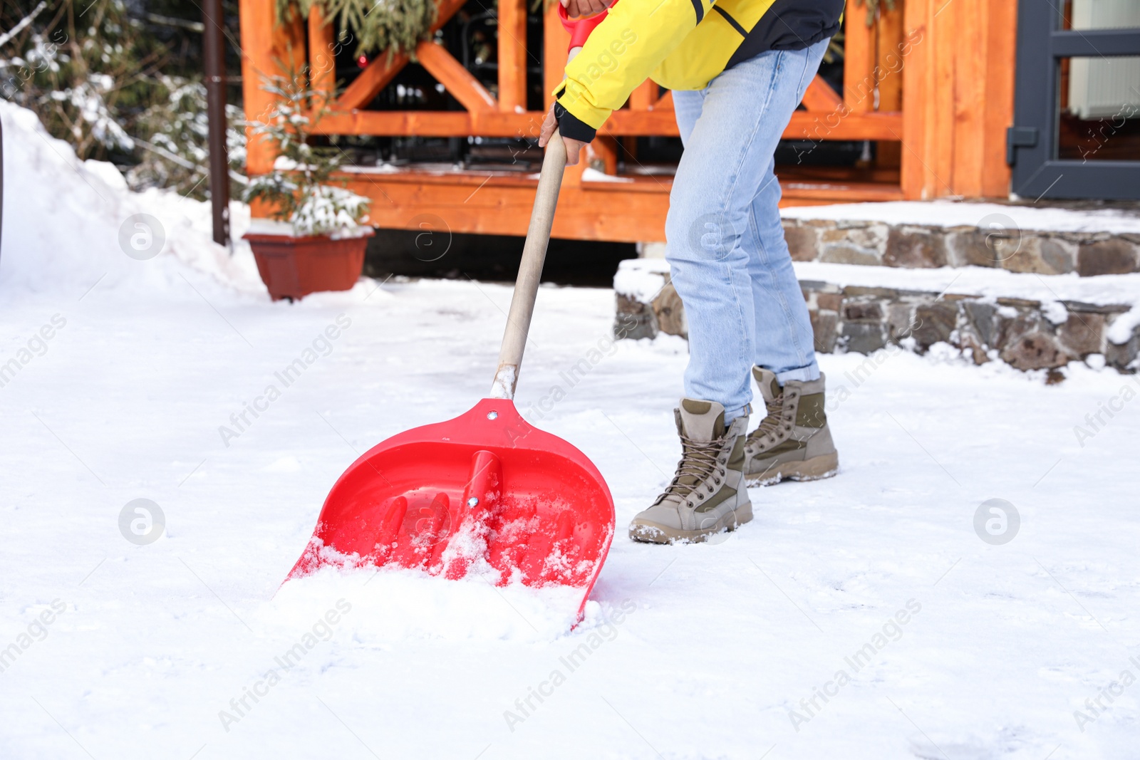 Photo of Man removing snow with shovel on winter day, closeup