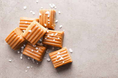 Photo of Salted caramel on light grey table, flat lay. Space for text