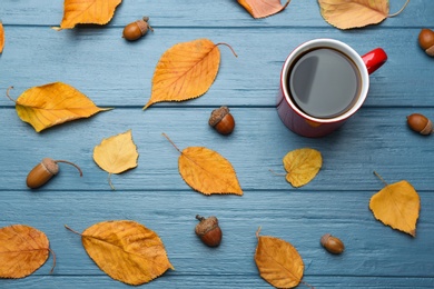 Photo of Flat lay composition with cup of hot drink on blue wooden table. Cozy autumn atmosphere