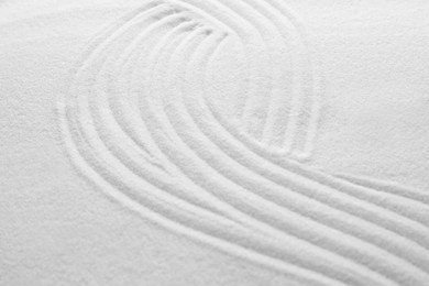 White sand with pattern as background, closeup. Concept of zen and harmony