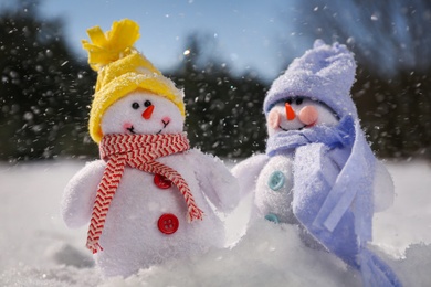 Photo of Cute small decorative snowmen outdoors on winter day