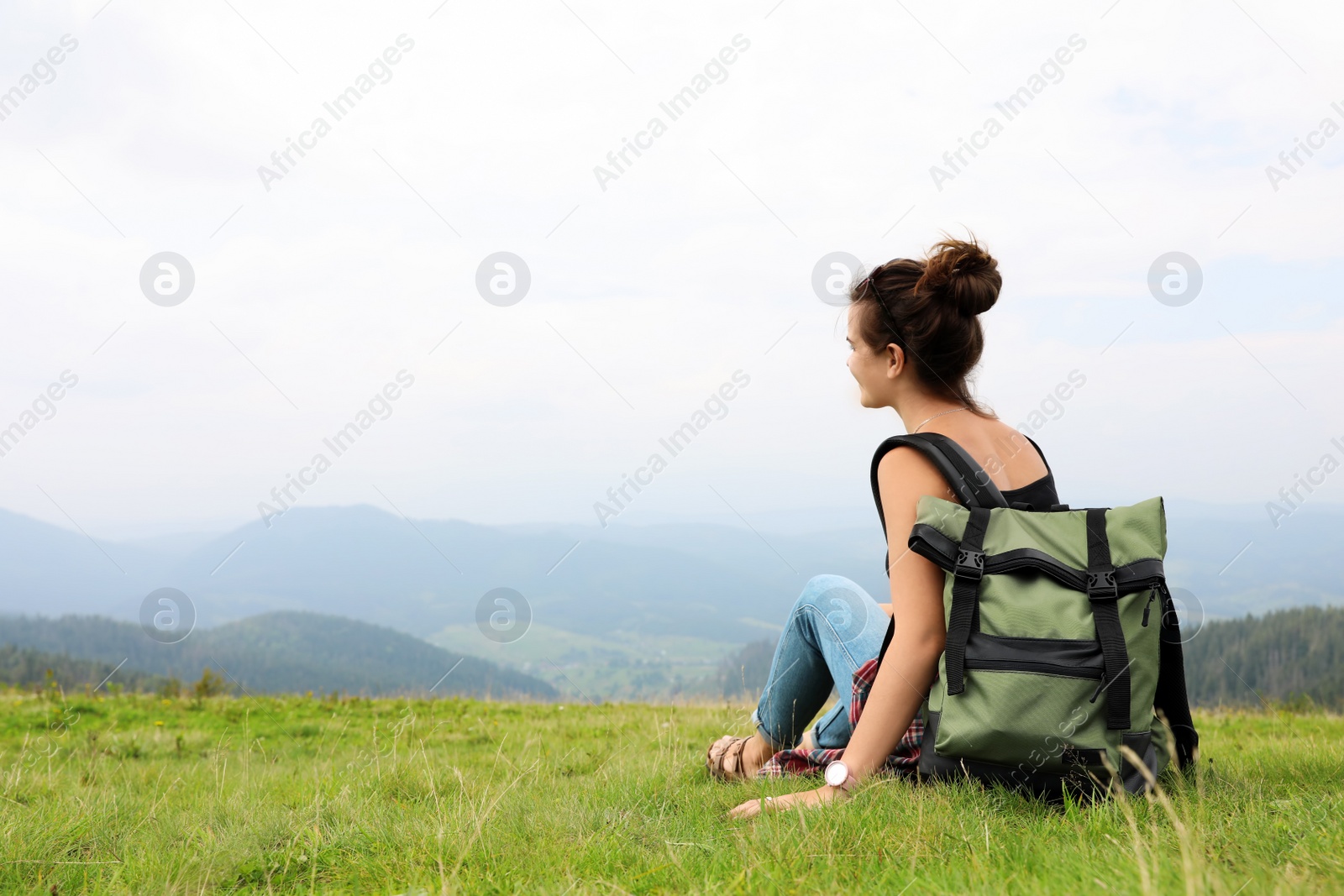 Photo of Woman with backpack in wilderness on cloudy day