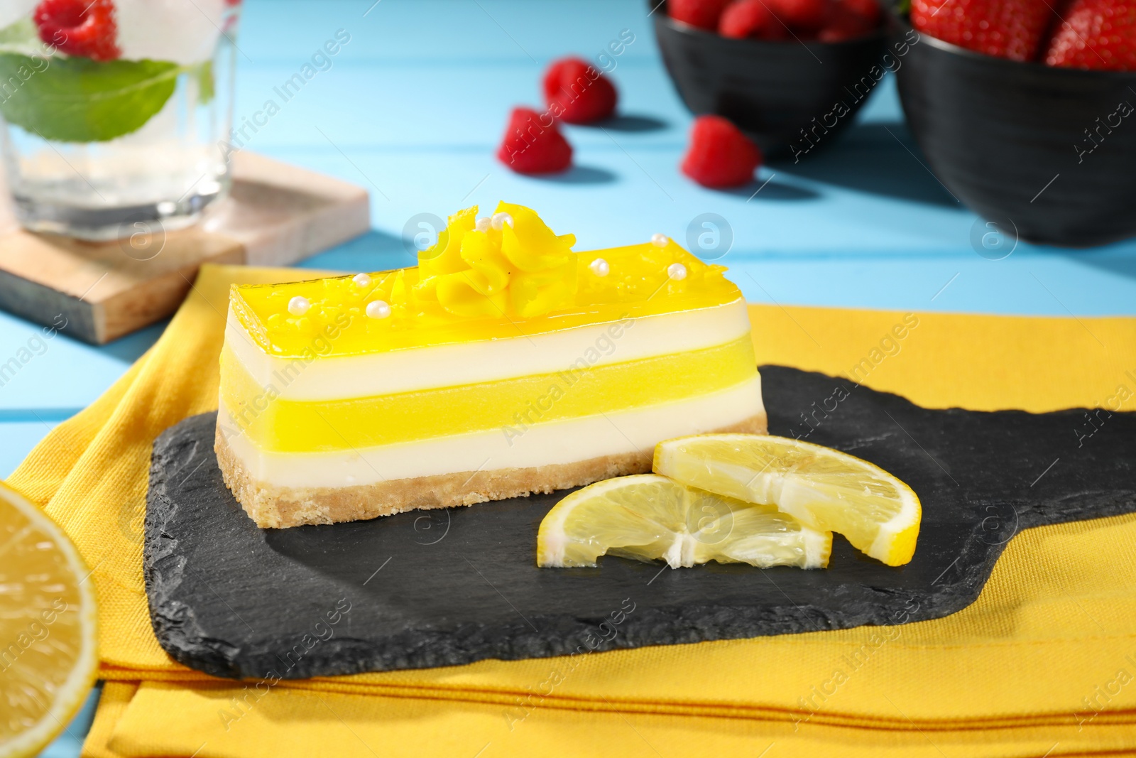 Photo of Delicious cheesecake with lemon on table, closeup