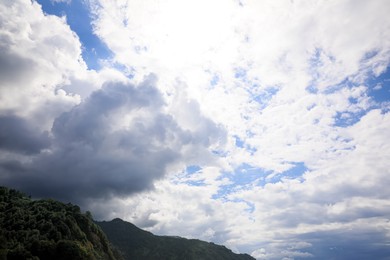 Photo of Picturesque view of mountain under beautiful sky with fluffy clouds