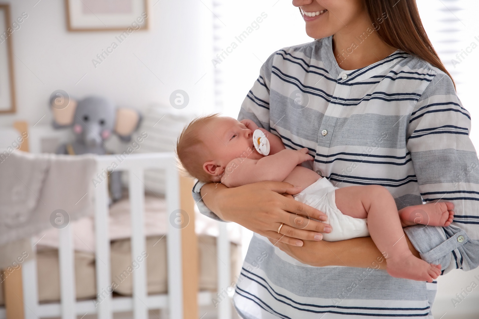 Photo of Mother with her newborn baby at home, closeup