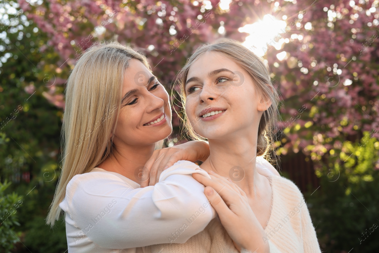 Photo of Happy mother with her daughter spending time together in park on sunny day