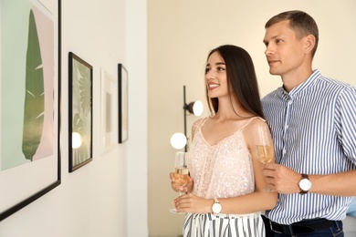 Young couple at exhibition in art gallery