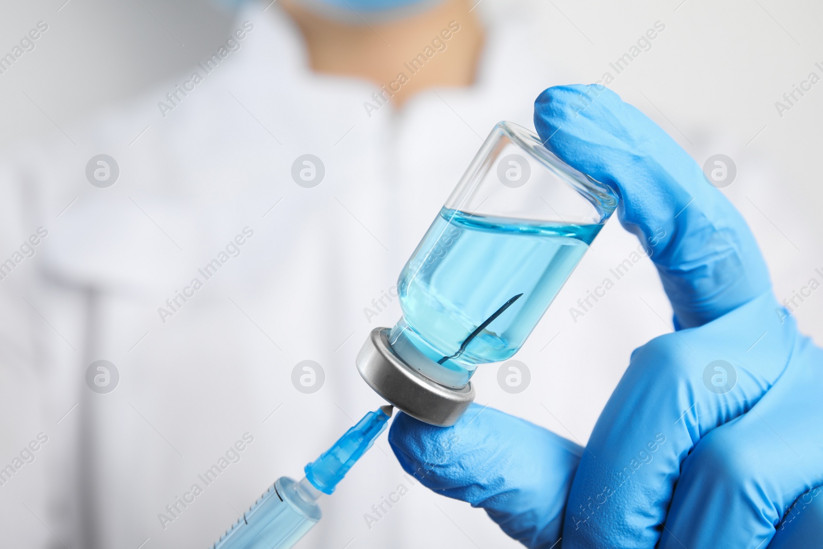 Photo of Doctor filling syringe with medication, closeup. Vaccination and immunization