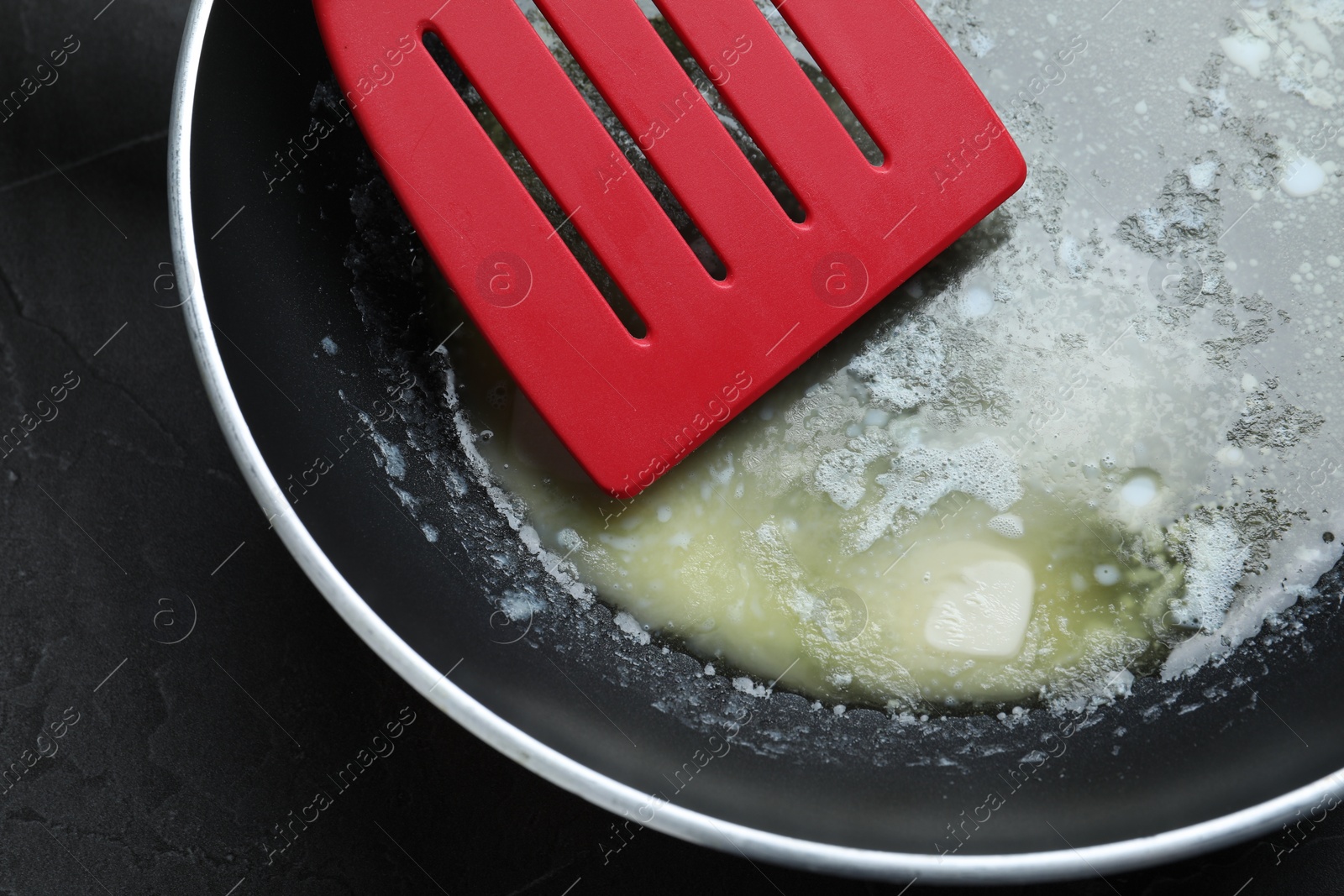 Photo of Melting butter in frying pan, closeup view