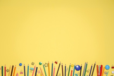 Photo of Bright stationery on yellow background, flat lay. Space for text