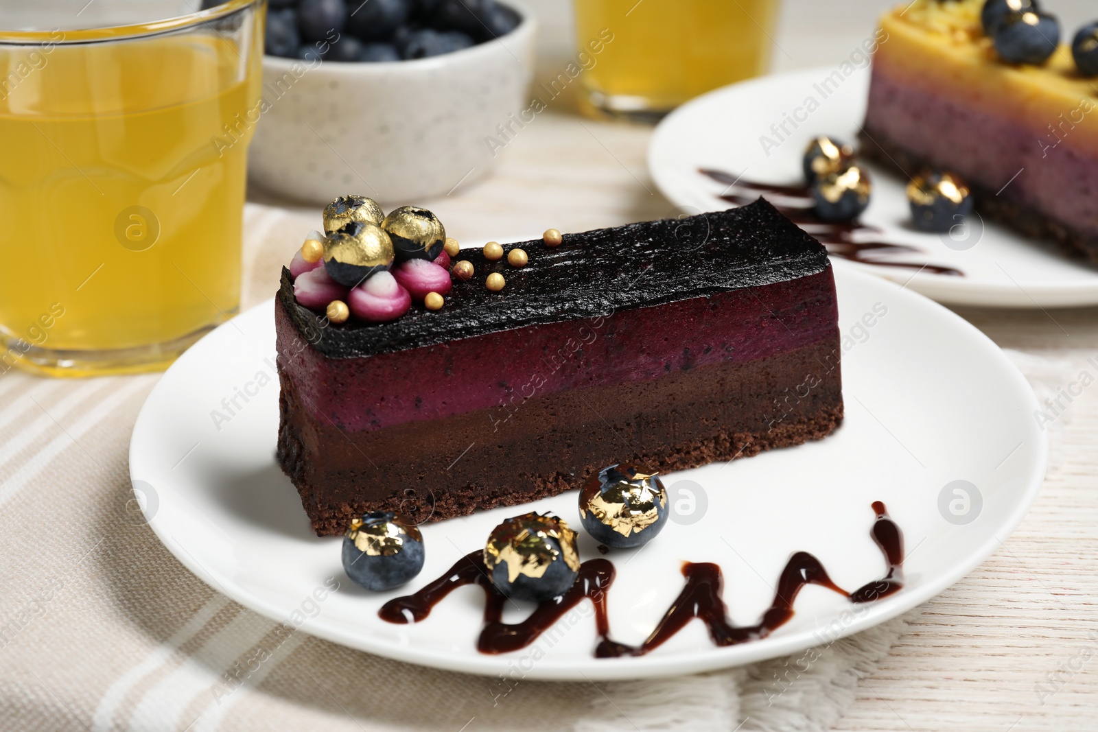 Photo of Delicious cake with blueberry on white wooden table, closeup