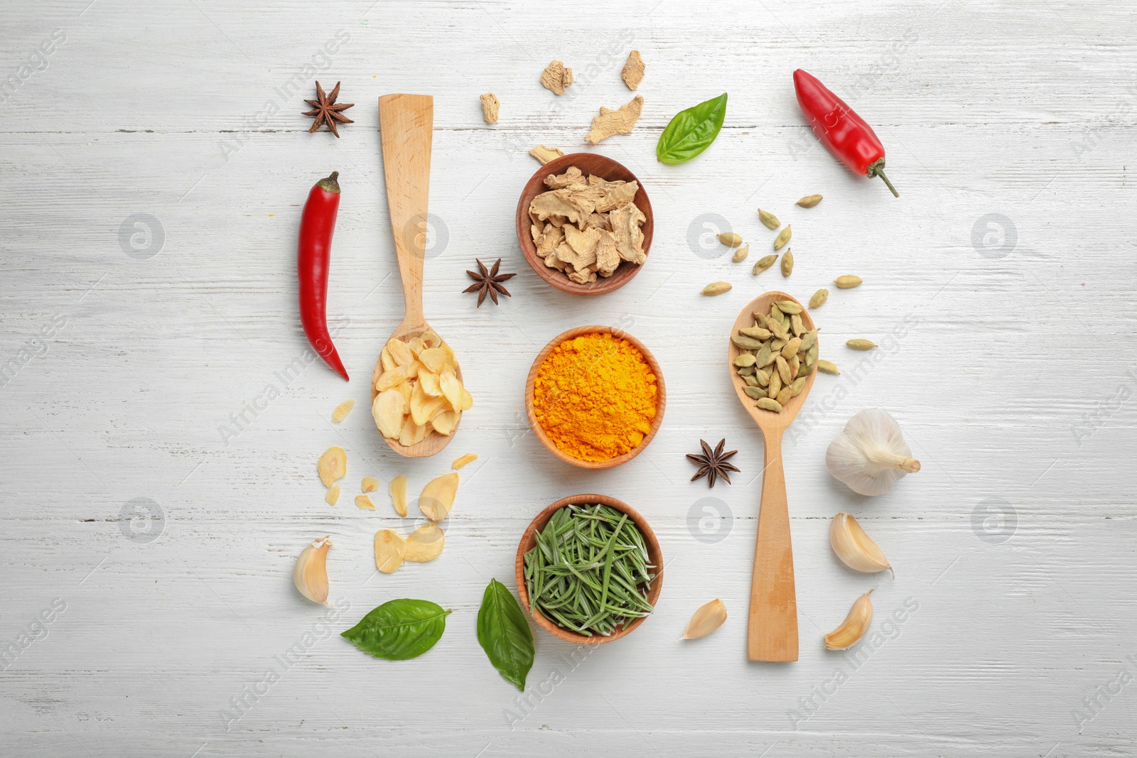 Photo of Flat lay composition with different aromatic spices on wooden background