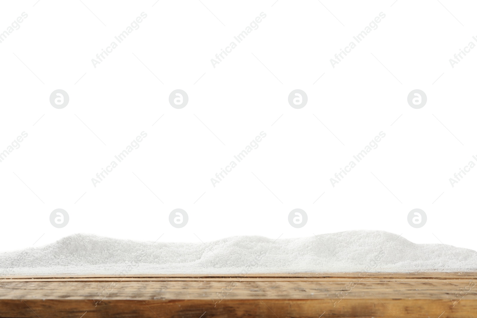 Photo of Artificial snow on wooden table against white background. Christmas decor