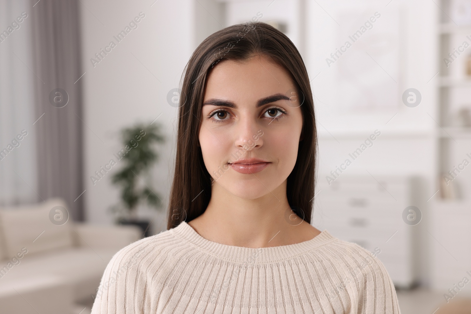 Photo of Portrait of beautiful young woman at home