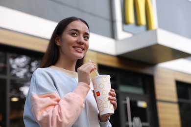 Photo of Lviv, Ukraine - September 26, 2023: Woman with McDonald's drink outdoors, space for text