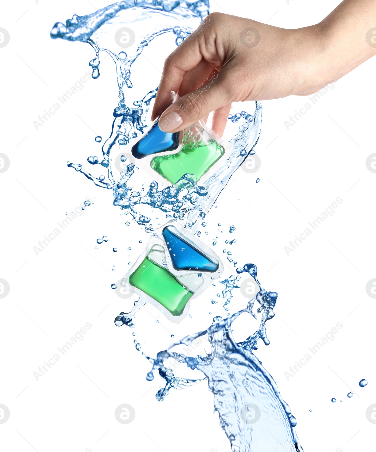 Image of Splashes of water and woman holding laundry capsule on white background, closeup. Detergent pods