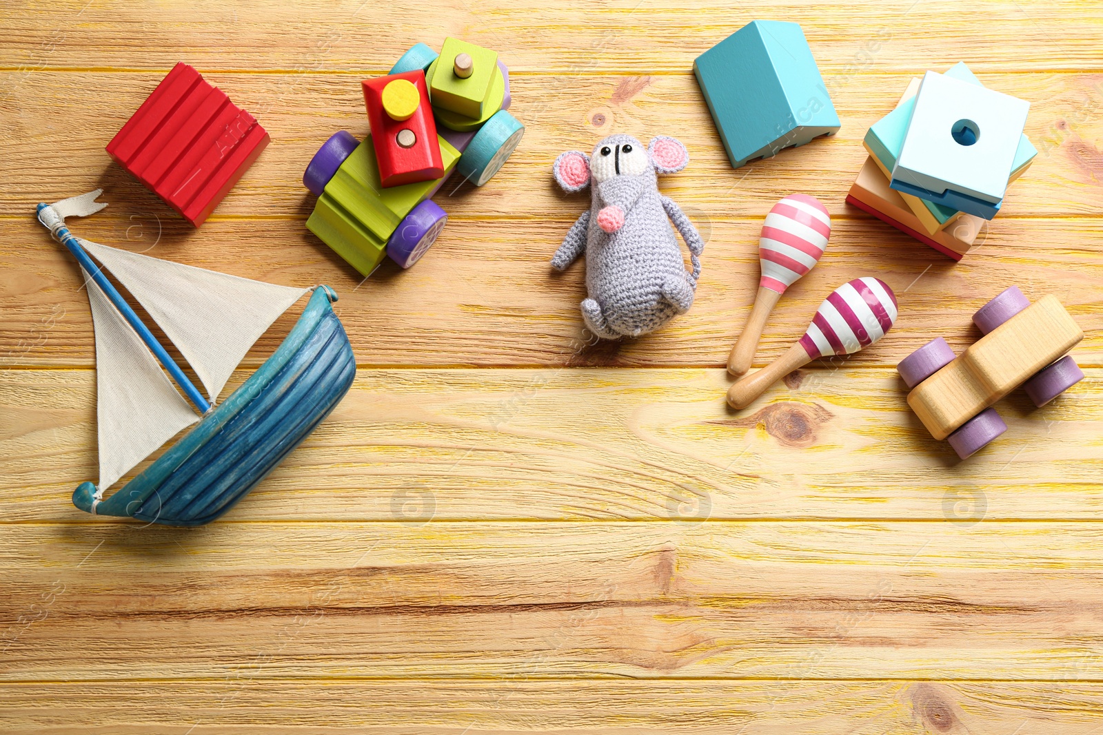 Photo of Different toys on wooden background, flat lay. Space for text