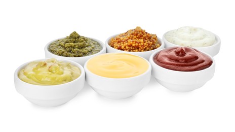 Many different sauces in bowls on white background