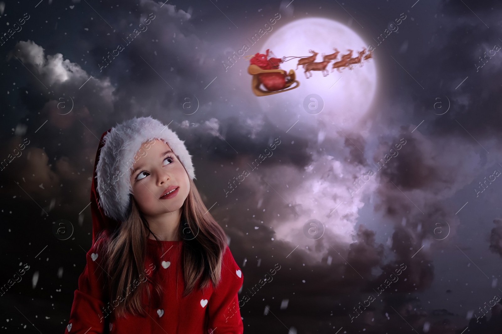 Image of Cute little child and Santa Claus flying in his sleigh on background. Christmas celebration