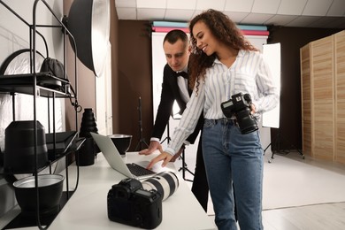 Handsome model with professional photographer in studio