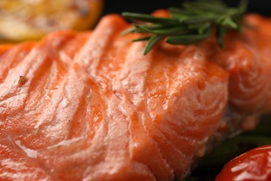 Photo of Tasty grilled salmon with rosemary, closeup view