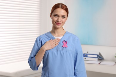 Photo of Mammologist with pink ribbon in hospital. Breast cancer awareness