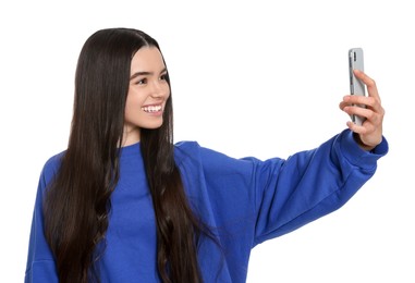 Photo of Teenage girl taking selfie on white background