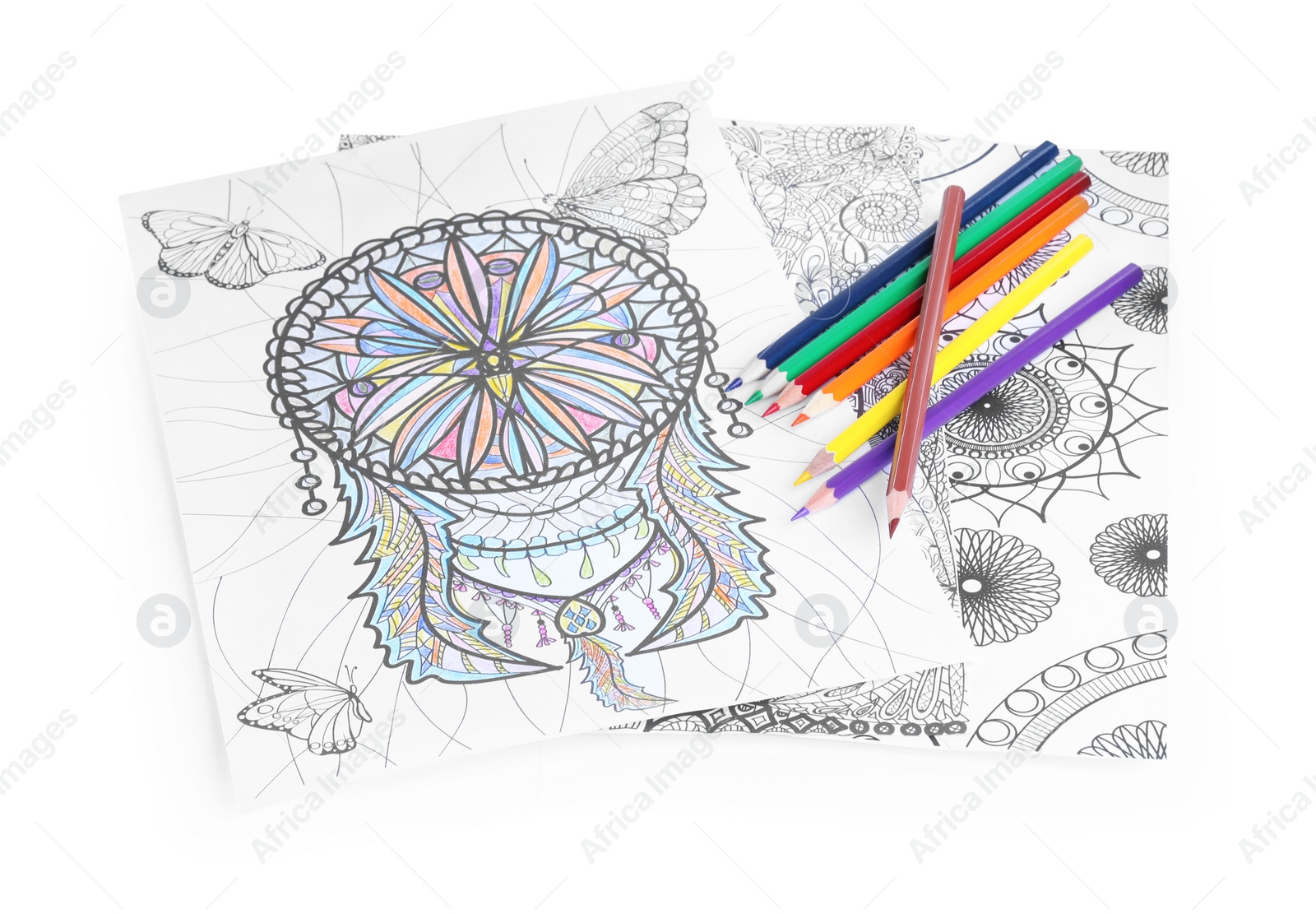 Photo of Antistress coloring pages and pencils on white background